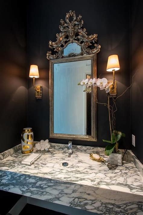 French Powder Room Features Walls Painted Bold Black Lined With A