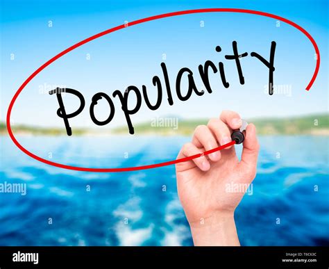 Man Hand Writing Popularity With Black Marker On Visual Screen Stock