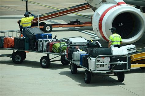 Airport Ground Support Staff Loading Luggage Suitcases And Cargo Into