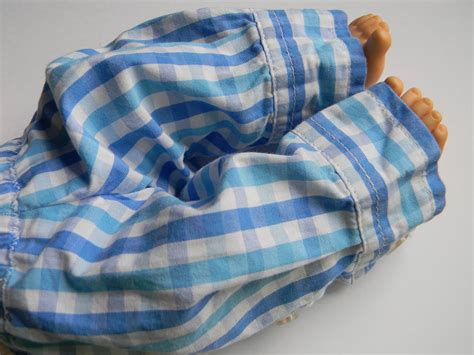 Upcycling a boys shirt into baby doll clothes.