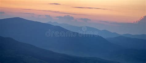 Panorama Smoky Silhouette Of The Carpathian Mountains At Sunset Stock