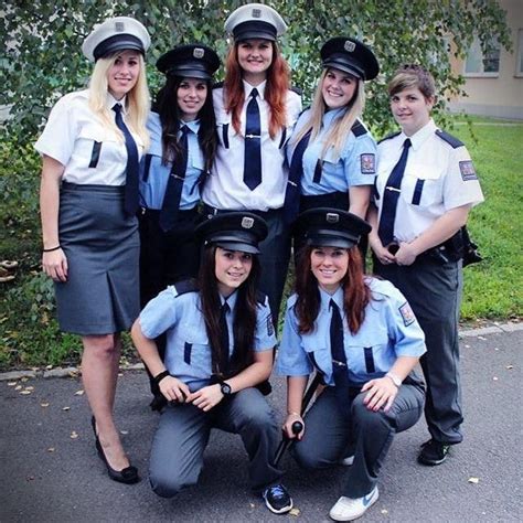 a group of women in police uniforms posing for a photo