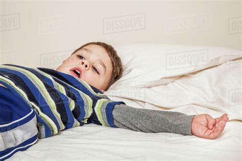 Young Boy Laying On A Bed Connecticut United States Of America