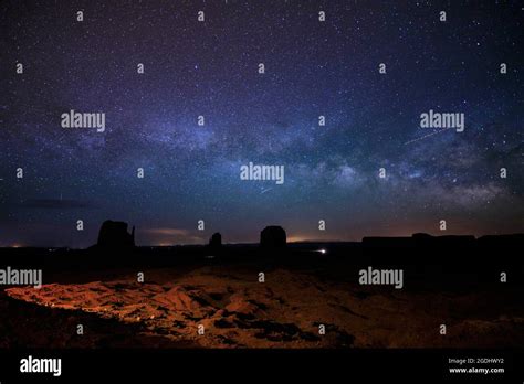The Milky Way And Night Sky Rises Above Monument Valley In Arizona