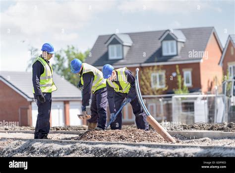 Apprentice Builders Digging On Building Site Stock Photo Alamy
