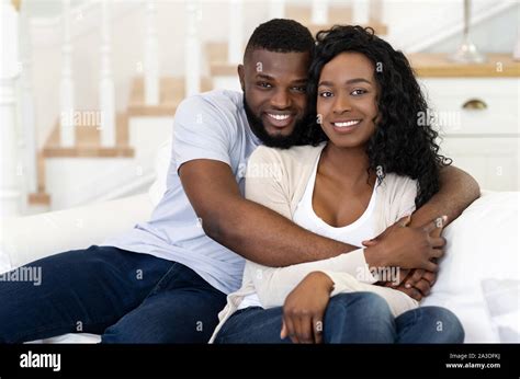 Smiling Black Husband And Wife Looking At Camera And Embracing Stock