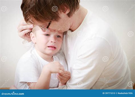 Father Comforting His Crying Daughter Stock Image