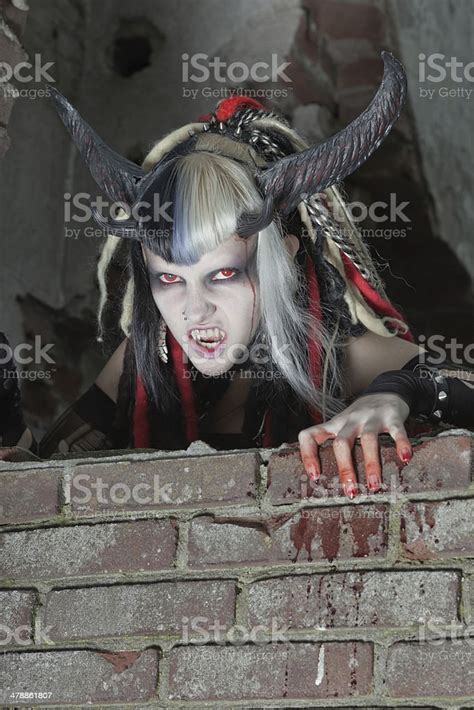 Scary Hungry Female Demon Crawling Over Old Dirty Brick Wall Stock