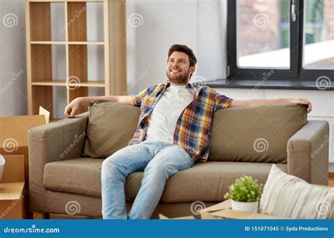 Happy Man With Boxes Sitting On Sofa At New Home Stock Image Image Of Accommodation Mortgage