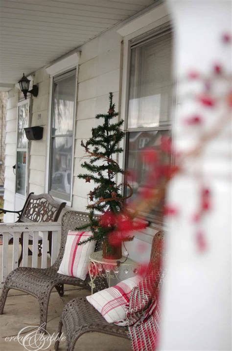 Front Porch Decorated For Christmas Using A Tablecloth