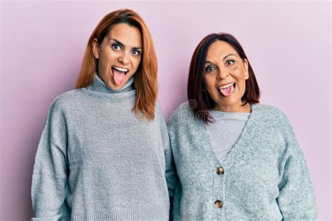 Latin Mother And Daughter Wearing Casual Clothes Sticking Tongue Out Happy With Funny Expression