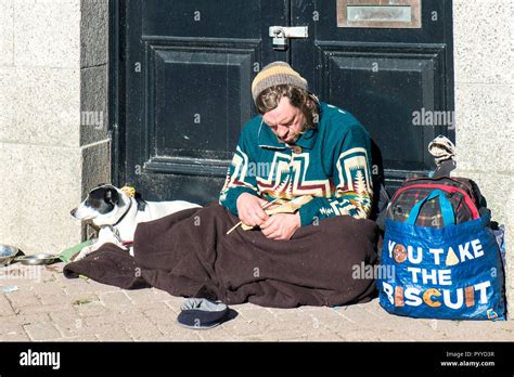 A Homeless Man And His Dog Sitting In A Doorway Stock Photo Alamy