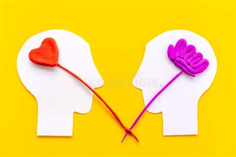 Relations And Communication Concept Brain And Heart On Two Paper Heads
