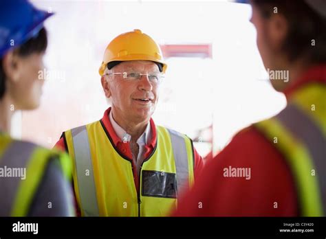 Architect Talking To Some Builders Stock Photo Alamy