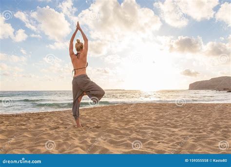 Woman Practicing Yoga On Sea Beach At Sunset Stock Photo Image Of