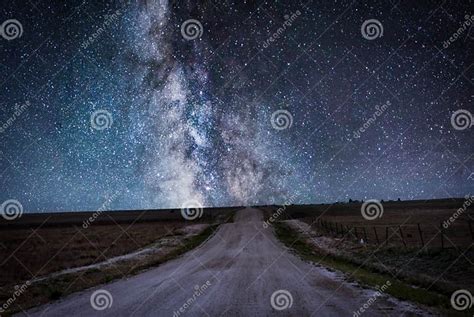 A Dirt Country Road Leads To The Stars Of The Galaxy In A Midnight
