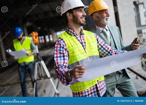 Engineer Foreman And Worker Discussing In Building Construction Site