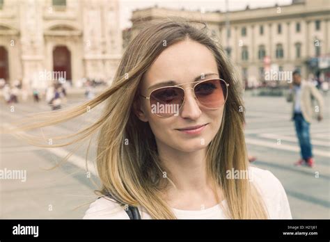 Italy Milan Portrait Of Smiling Blond Tourist With Sunglasses In Front Of Milan Cathedral
