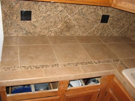 Once a kitchen staple throughout the 70s, 80s, and 90s, these days thrifty homeowners see tile as an affordable alternative to more expensive counter materials such the backsplash is an affordable builder grade ceramic tile. Kitchen- Porcelein Tiled Countertop & Backsplash