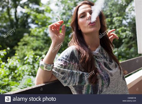 Woman Smoking On Balcony Outdoors Stock Photo Alamy