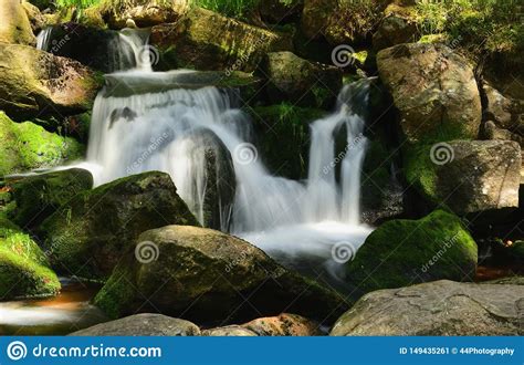 Beautiful Cascade Waterfall Over Green Mossy Rocks In The Forest Stock
