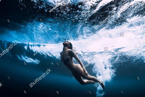 Woman In Bikini Dive Without Surfboard Underwater With Ocean Wave Duck Dive Under Barrel Wave