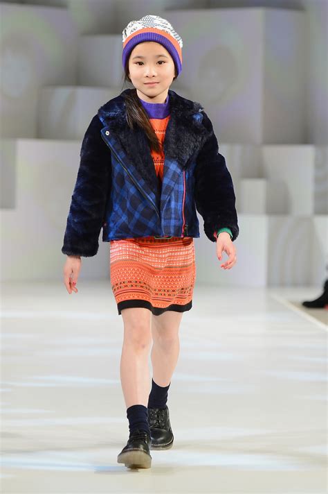 A Model Wearing Kenzo Look 1 Autumnwinter 13 Walks The Runway At The Global Kids Fashion Week