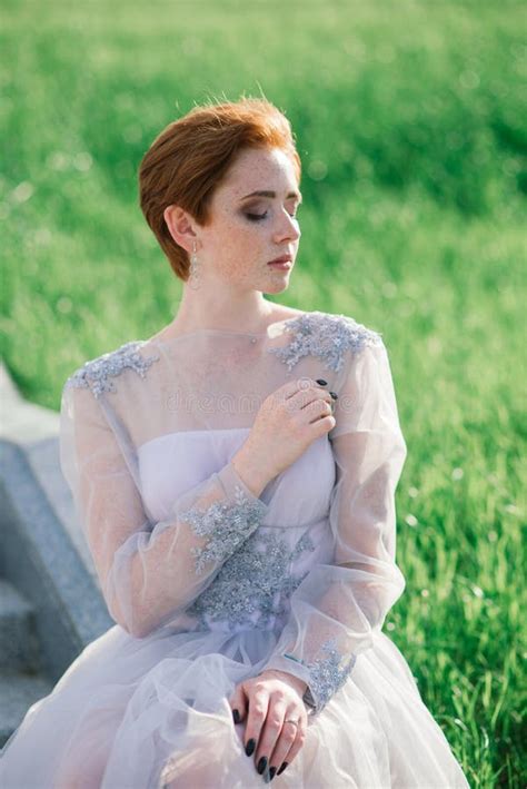 Pretty Young Caucasian Redhead Girl In A Garden And Outside With Her Wedding Bouquet Beautiful