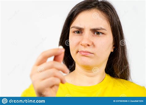 A Woman With A Disgruntled Face Holds A Pill In Her Hand Harm From