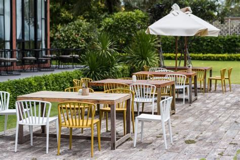 Table Sets In Outdoor Cafes In Green Garden Outside Restaurant Stock