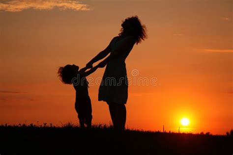 Mother And Daughter On Sunset Watching On Sky Mother And Daughter On A