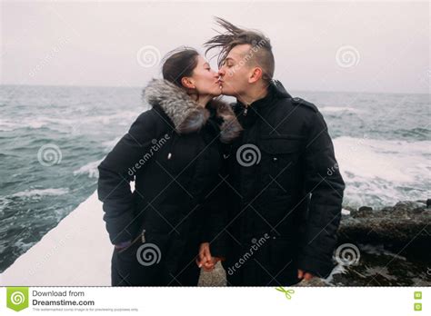 Affectionate Young Happy Couple Standing On Pier By The Sea And