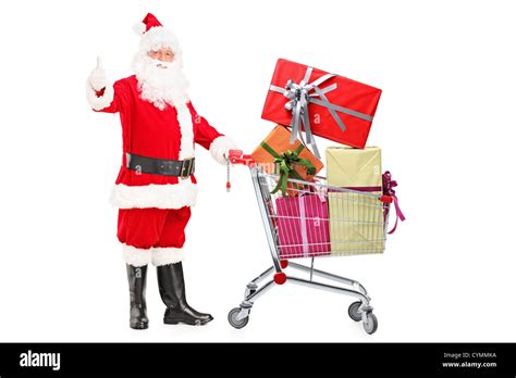 Santa Claus Holding A Shopping Cart Full Of Ts And Giving A Thumb Up