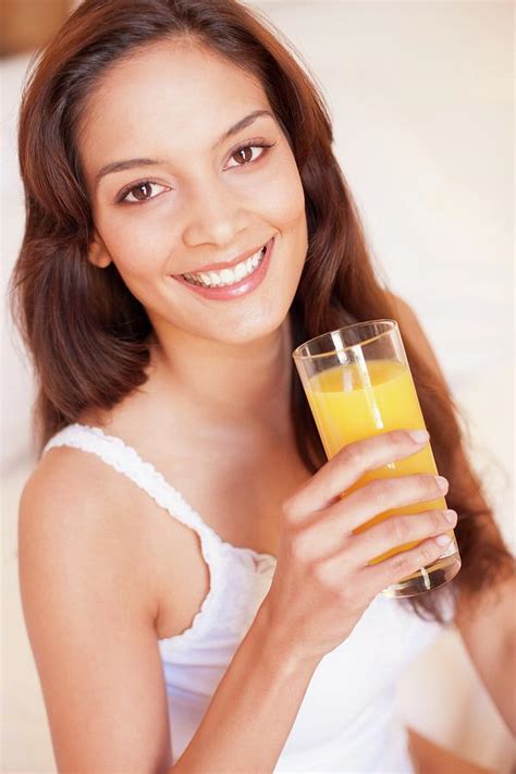 Woman Drinking Fruit Juice Photograph By Ian Hooton Science Photo