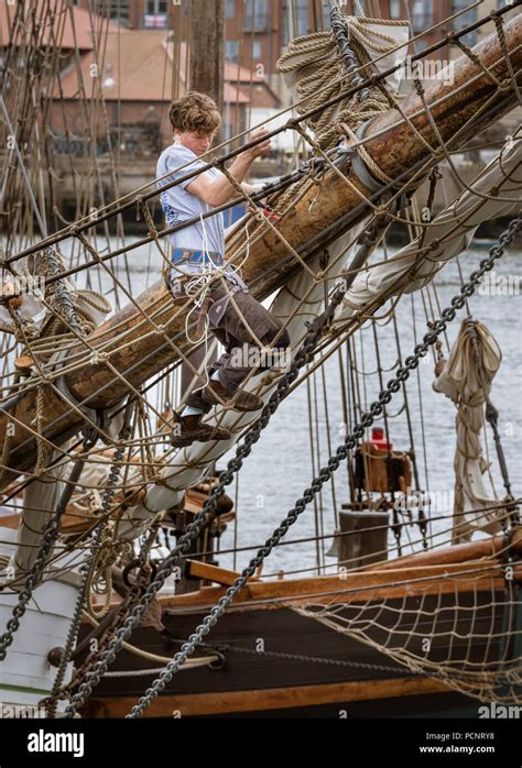 Sailor Working On The Rigging Of A Sailing Ship In Harbour During The