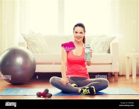 Smiling Girl With Bottle Of Water After Exercising Stock Photo Alamy