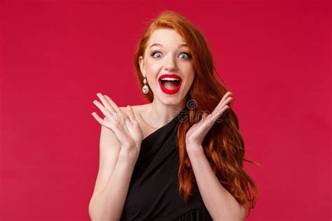 excited charismatic redhead woman triumphing look glad and happy for person winning award