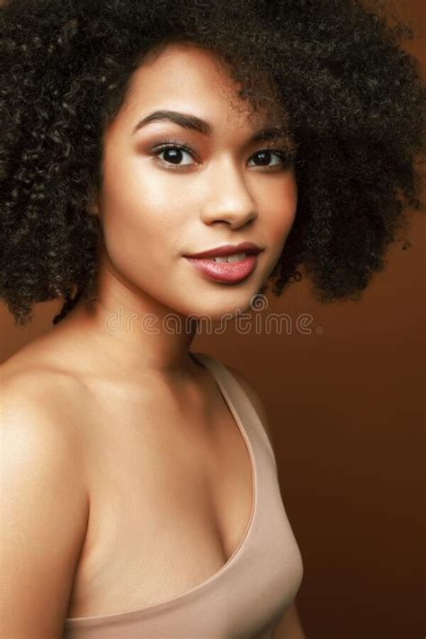 Pretty Young African American Woman With Curly Hair Posing Cheerful