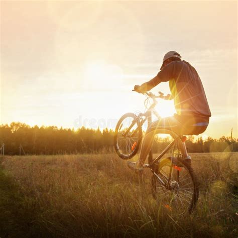 Young Man Riding A Bike At Sunset Stock Image Image Of Downhill
