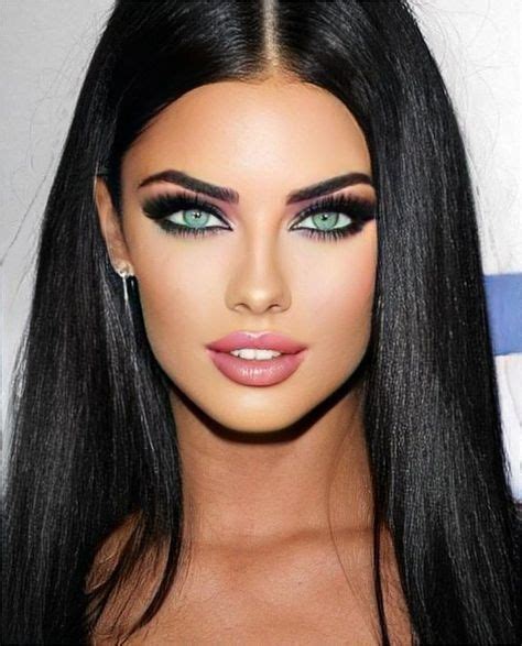 A Woman With Long Black Hair And Green Eyes