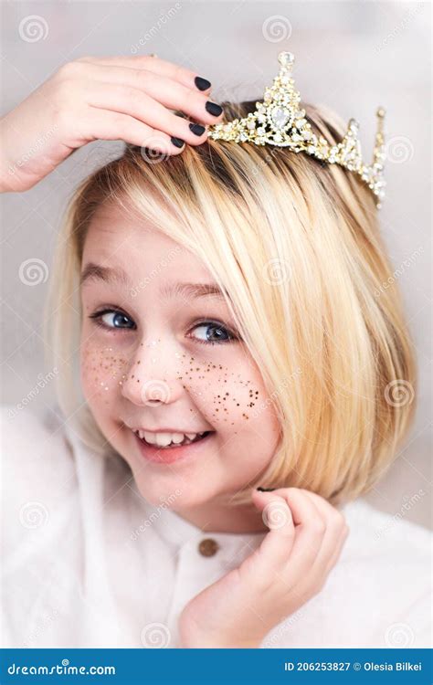 Portrait Of Beautiful Happy Androgynous Boy Wearing Tiara Golden