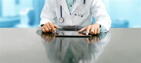 Doctor With Tablet Computer At Hospital Office Stock Photo Image Of