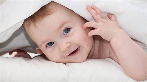 Grey Eyes Baby Is Lying Down On White Bed Covered With White Towel Hd
