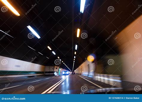 Motion Blur Driving Car At Speed Through A Tunnel At Night Stock Photo