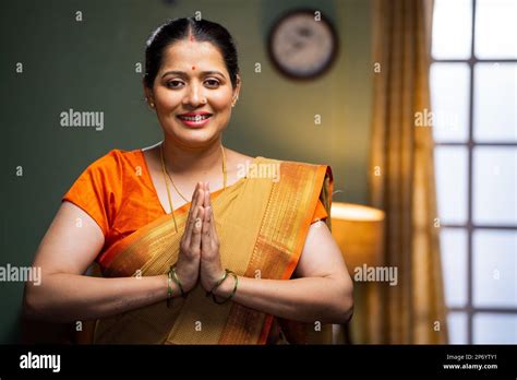 Happy smiling woman doing namaste or greeting by looking at camera