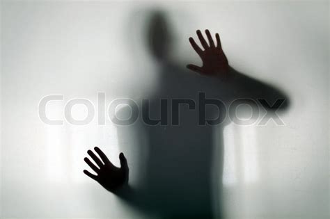 Shadowy Figure Behind Glass Stock Image Colourbox
