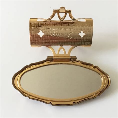 vintage stratton lipview lipstick holder and mirror with a peacock design