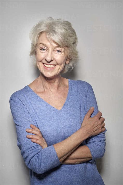 Portrait Of Smiling Mature Woman Wearing Blue Pullover Stock Photo
