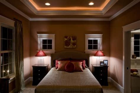 A tray ceiling features a central section that is elevated by several inches (or even feet) above the room's surrounding perimeter, making it ideal for painted color schemes and murals, mirrors, and hidden lighting fixtures. tray ceiling in master bedroom with rope lighting and ...