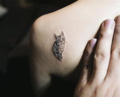 A cute tattoo of a cat sitting on the moon with stars in the sky. 45 Cat Tattoos For True Cat Lovers - TattooMagz